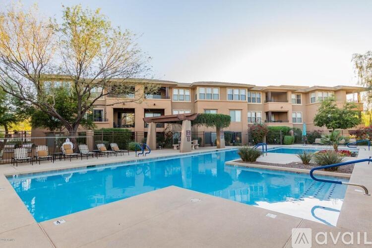 A large swimming pool in front of a building with a sign that says "available".