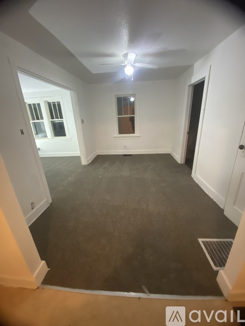 A room with a window and a door is available for rent.