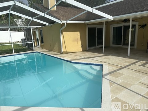 A pool under a white canopy.