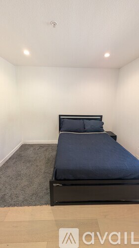 A bedroom with a bed and a carpet.