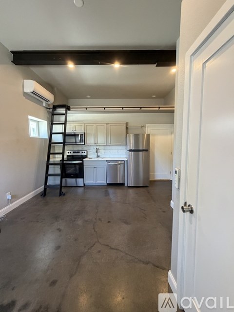 A kitchen with white cabinets and a black stove top oven.