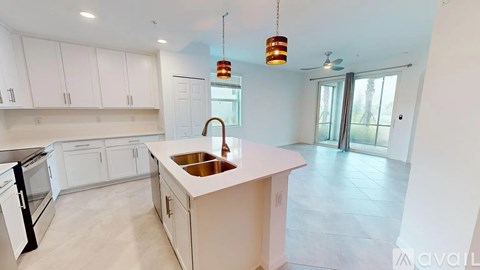 A kitchen with white cabinets and a sink.