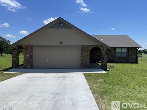 A house with a garage and a driveway in front.