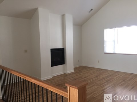 A living room with a television and a window.
