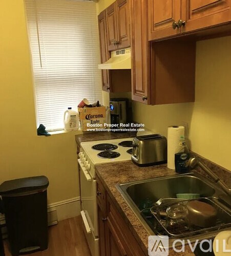 A kitchen with a sink, stove, and toaster.