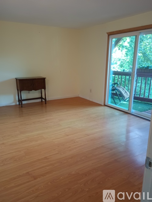 A room with wooden floors and a table.