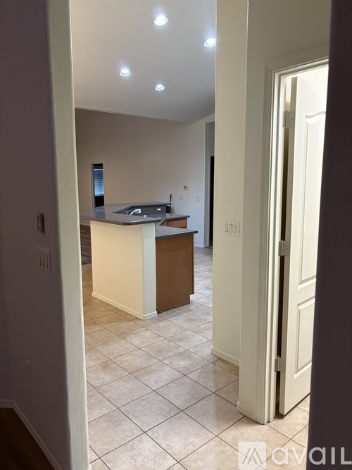 A kitchen with a white counter and brown cabinets.