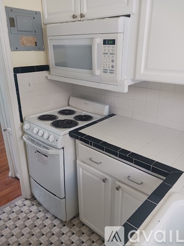 A white kitchen with a microwave above the stove.
