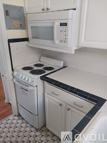A white kitchen with a microwave above the stove.