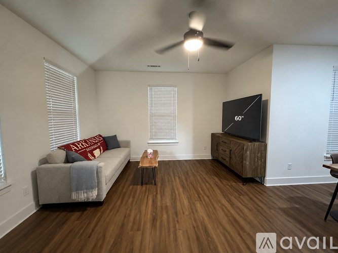 A living room with a couch, a coffee table, and a television.
