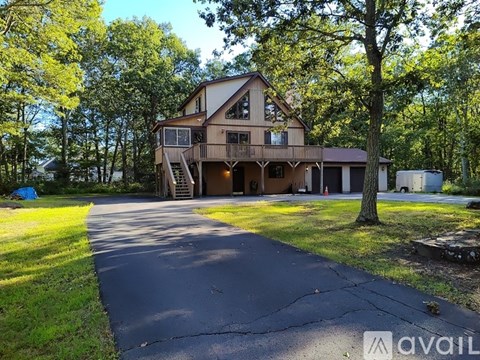 A house with a driveway in front of it.