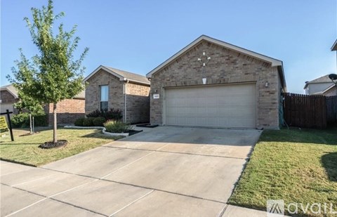 A house with a garage and a driveway in front.