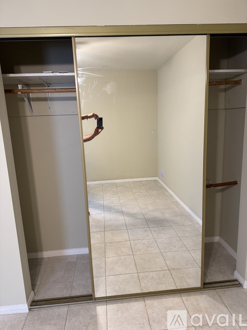 A person is taking a picture of an empty room through a glass door.