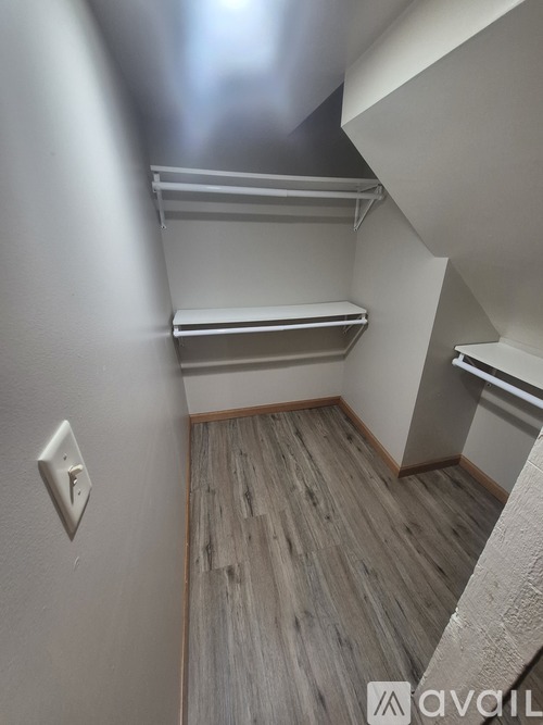 A small room with a light switch on the wall.