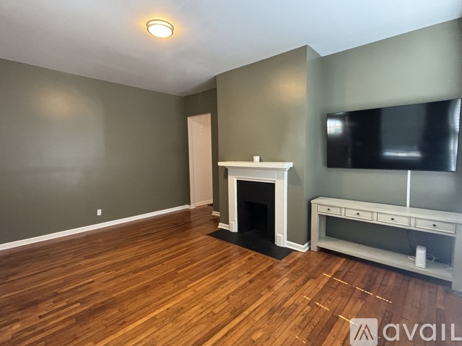 A living room with a fireplace and a television.