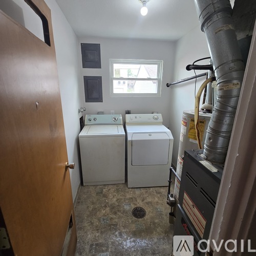 A small laundry room with a washer and dryer.