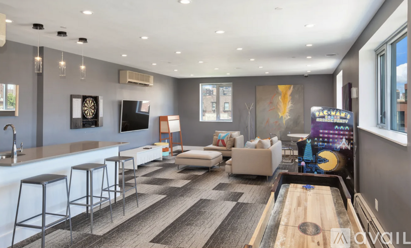 A modern living room with a bar area and a pool table.