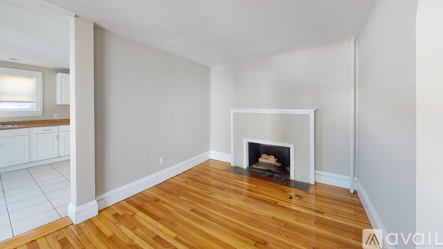 A living room with a fireplace and hardwood floors.