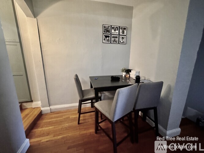 A dining room with a table and chairs.