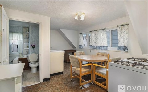 A kitchen with a table and chairs in the middle of the room.
