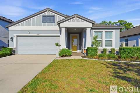 A modern house with a garage and a well-maintained lawn.