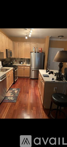 A kitchen with wooden cabinets and a refrigerator.