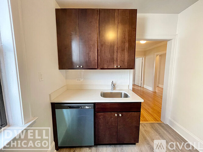 A kitchen with a sink and a dishwasher.