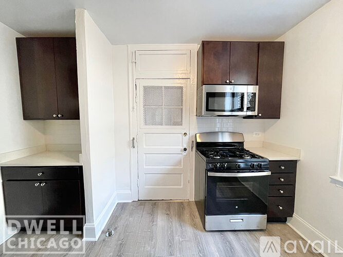 A kitchen with a stove, oven, and cabinets.