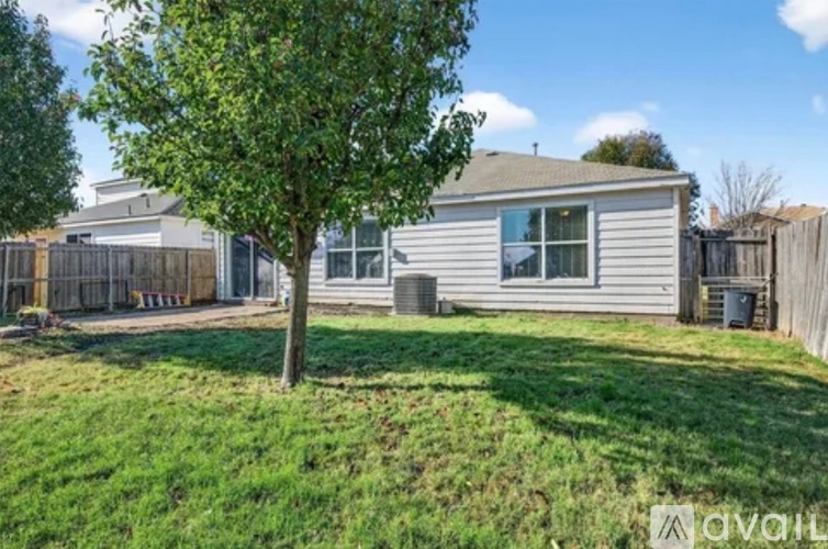 A house with a tree in front of it.