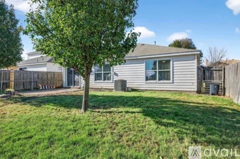 A house with a tree in front of it.