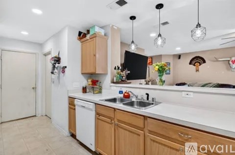 A kitchen with wooden cabinets and white appliances.