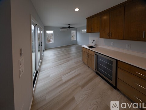 A kitchen with wooden cabinets and a ceiling fan.