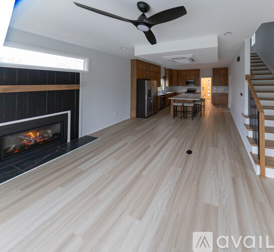 A modern living room with a fireplace and a wooden floor.