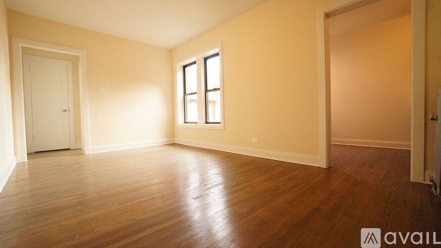 A room with wooden floors and a window.