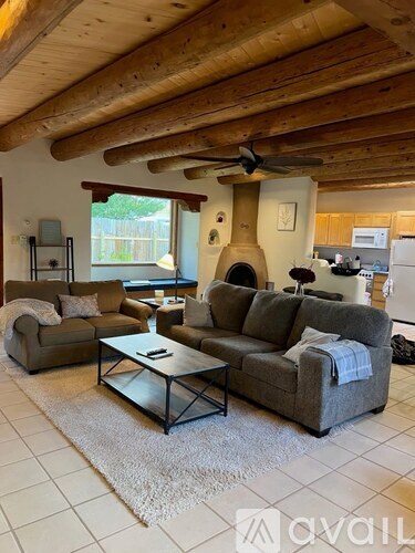 A living room with a grey couch and a coffee table.