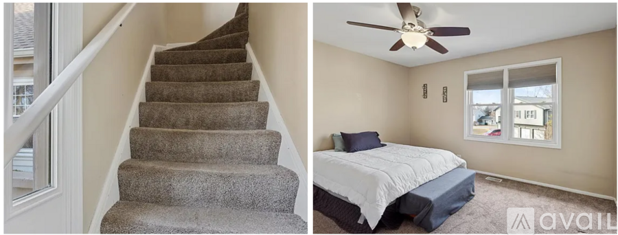A bedroom with a bed and a staircase.