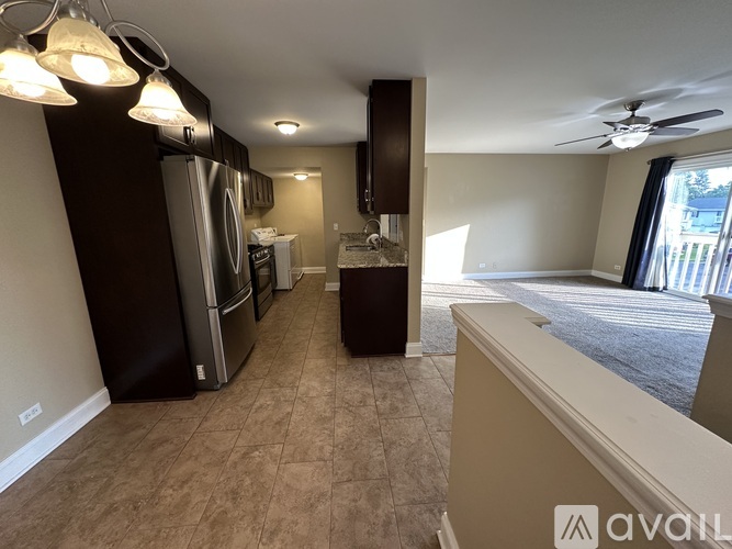 A kitchen with a refrigerator, oven, and sink is available for rent.
