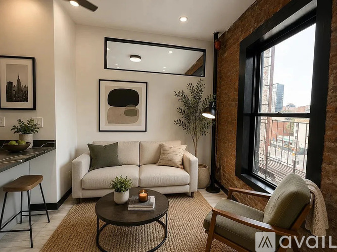 A living room with a couch, a chair, a table, and a window.
