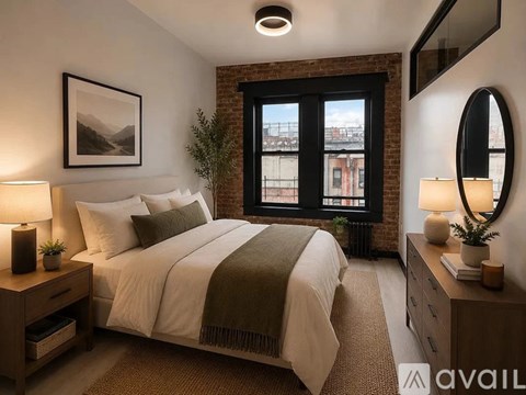 A bedroom with a large bed, a window with a view, and a lamp on the nightstand.