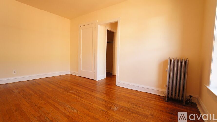 A room with wooden floors and a white door.