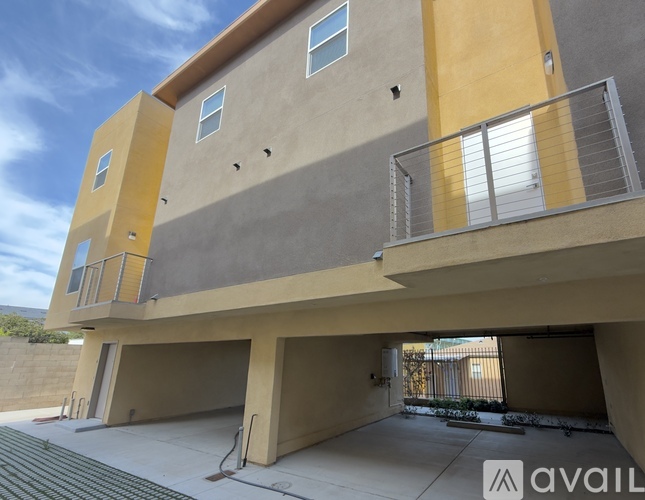 A modern two-story building with a balcony on the upper floor.