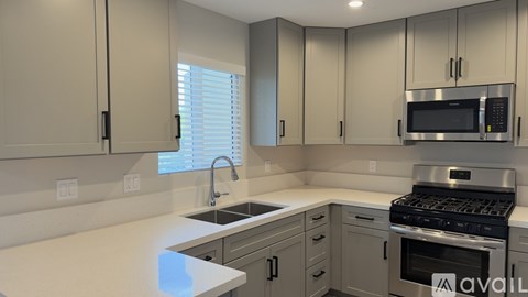 A modern kitchen with a stainless steel oven and microwave.