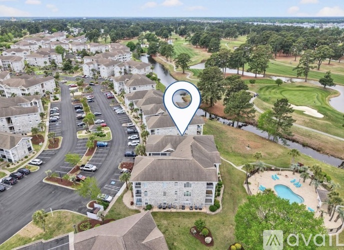 An aerial view of a neighborhood with a pool and a golf course.