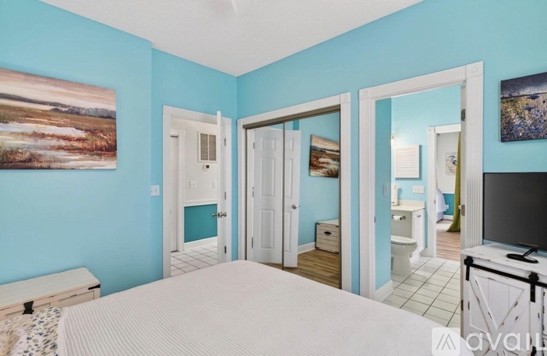 A bedroom with a bed, dresser, and mirror.