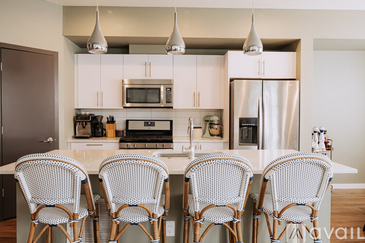 A kitchen with a white table and chairs.