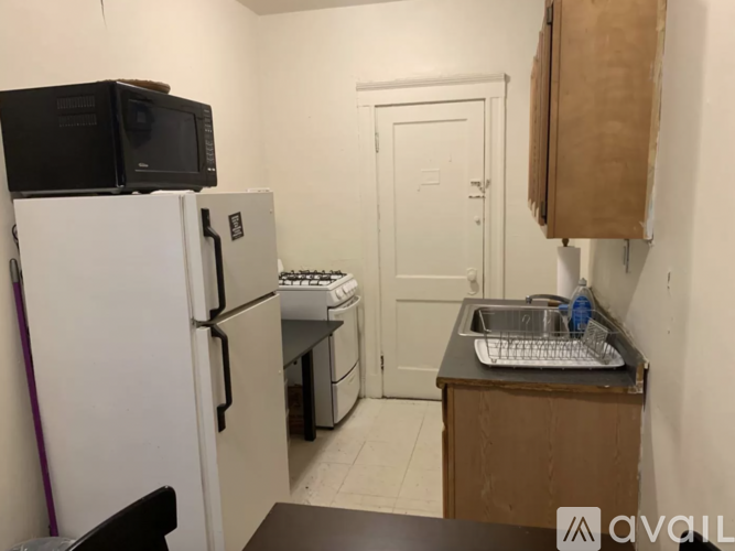 A kitchen with a white fridge, a microwave, a sink and a stove.