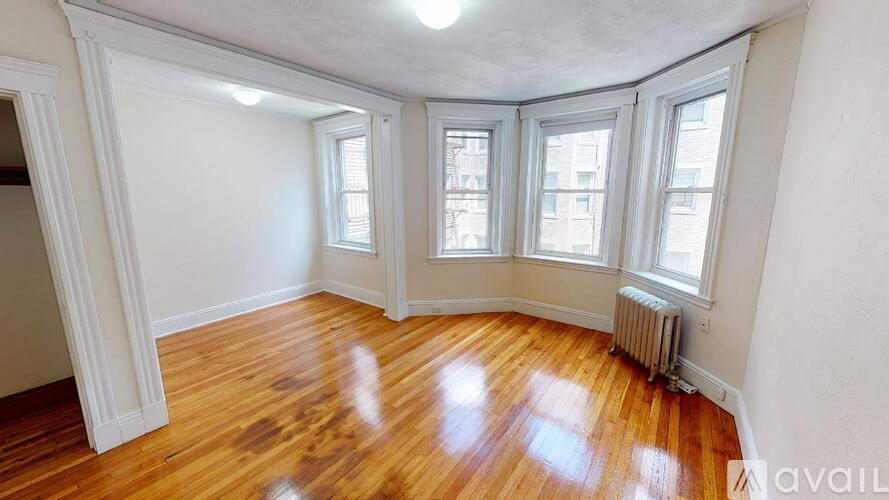 A room with wooden floors and white walls.