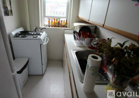 A small kitchen with a washing machine and a sink.