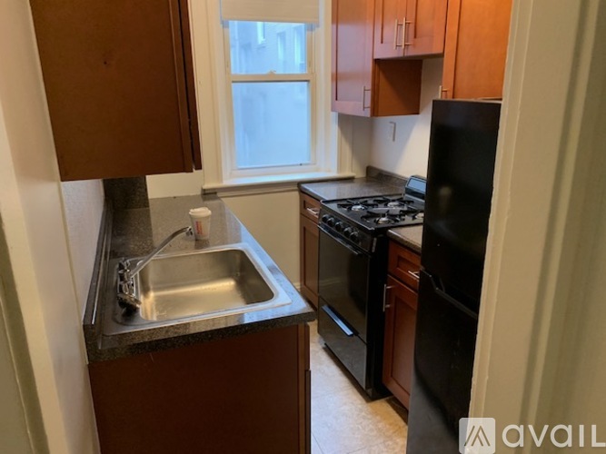A kitchen with a sink, stove, and refrigerator.