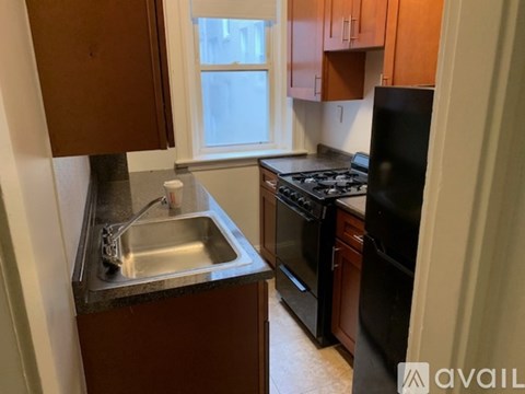 A kitchen with a sink, stove, and refrigerator.